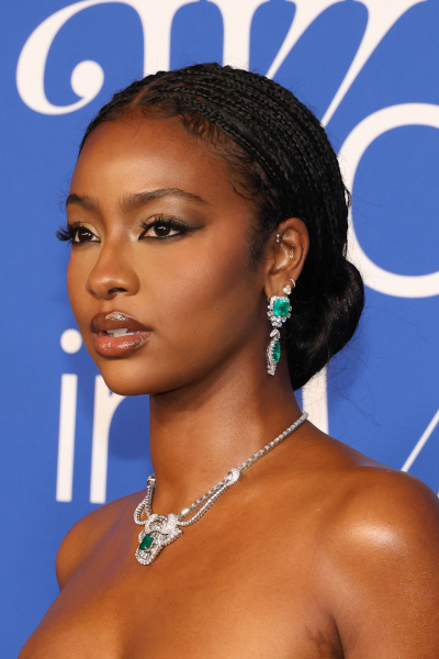 Justine Skye wearing small knotless braids in a bun
