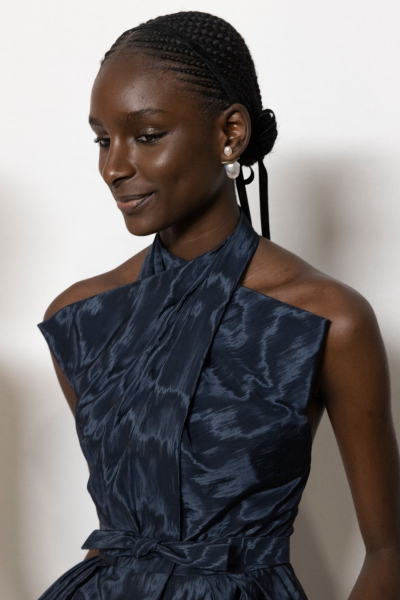 Model backstage at Christian Dior Couture Spring 2024 wearing cornrows